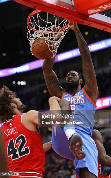 DeAndre Jordan of the LA Clippers dunks over Robin Lopez of the Chicago Bulls at the United Center on March 13, 2018 in Chicago, Illinois. NOTE TO...