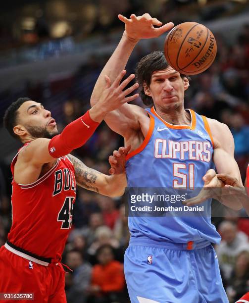 Boban Marjanovic of the LA Clippers looses control of the ball under pressure from Denzel Valentine of the Chicago Bulls at the United Center on...