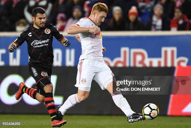 Club Tijuana's Alberto Garcia and New York Red Bulls Daniel Royer vie for the ball during the Concacaf Champions League 2nd Leg Quarter-final...