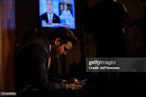 David Haas, Director of Mission Advancement for Catholic Vote, a Super-PAC checks early election results at an Election Night event for GOP PA...