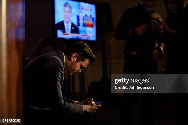 David Haas, Director of Mission Advancement for Catholic Vote, a Super-PAC checks early election results at an Election Night event for GOP PA...