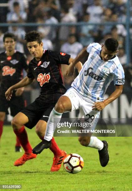 David Barbona of Argentinian Atletico Tucuman disputes the ball with Danilo Santacruz of Paraguayan Libertad during a 2018 Libertadores Cup football...
