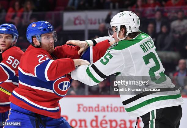 Karl Alzner of the Montreal Canadiens fights Brett Ritchie of the Dallas Stars in the NHL game at the Bell Centre on March 13, 2018 in Montreal,...