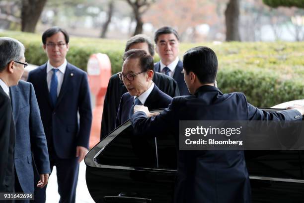 Lee Myung-bak, South Korea's former president, center, arrives at the Seoul Central District Prosecutors Office in Seoul, South Korea, on Wednesday,...