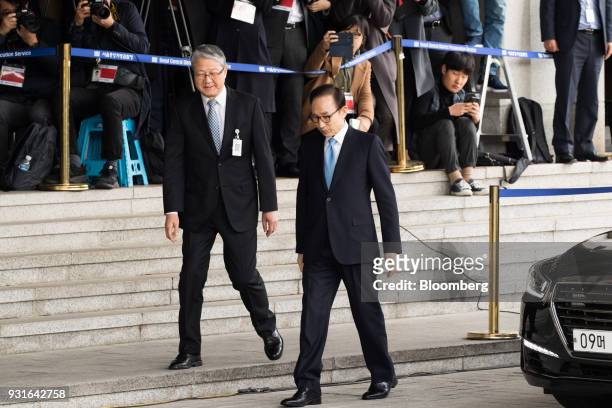 Lee Myung-bak, South Korea's former president, right, arrives at the Seoul Central District Prosecutors Office in Seoul, South Korea, on Wednesday,...
