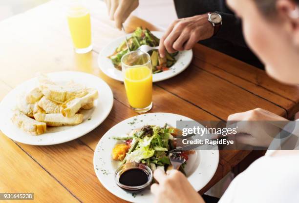 high angle look at young couple eating vegetarian meal - lunch top view stock pictures, royalty-free photos & images