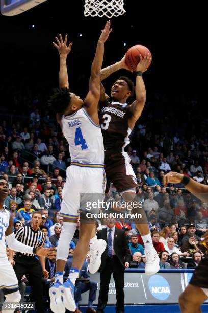 Jaylen Adams of the St. Bonaventure Bonnies drives to the basket against Jaylen Hands of the UCLA Bruins during the first half of the First Four game...