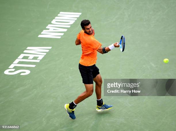 Yuki Bhambri of India plays a forehand in his match against Sam Querrey of the United States during the BNP Paribas Open at the Indian Wells Tennis...