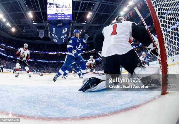 Miller of the Tampa Bay Lightning catches the puck against goalie Mike Condon of the Ottawa Senators during the second period at Amalie Arena on...