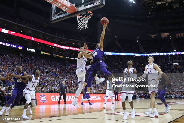 Kansas State Wildcats guard Mike McGuirl draws the foul and makes the basket with 12:33 left in the second half of a semifinal game in the Big 12...