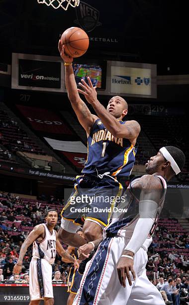 Dahntay Jones of the Indiana Pacers shoots against Terrence Williams of the New Jersey Nets during a game on November 17, 2009 at the IZOD Center in...