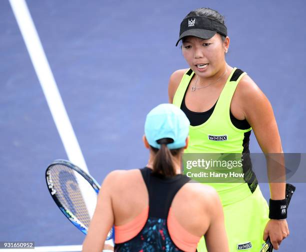 Vania King of the United States talks with Katarina Srebotnik of Slovenia in their match against Su-Wei Hsieh of Chinese Taipei and Barbora Strycova...