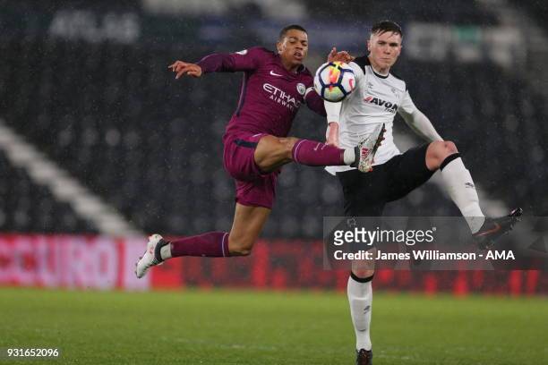 Lukas Nmecha of Manchester City and Max Hunt of Derby County during the Premier League 2 match between Derby County and Manchester City on March 9,...