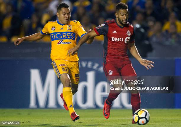 Albero Acosta of Mexico's Tigres vies for the ball with Justin Morrow of Canadas Toronto during the CONCACAF Champions League football match at the...