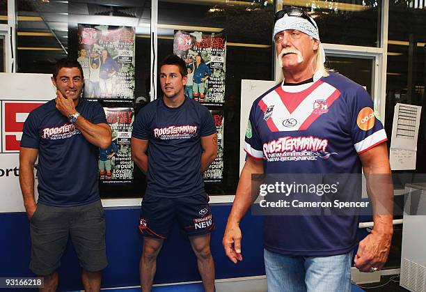 Wrestler Hulk Hogan listens to Roosters players Anthony Minichiello and Mitchell Pearce during a media opportunity with Sydney Roosters players at...