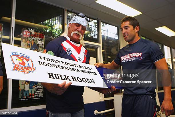 Wrestler Hulk Hogan is presented with a Roostermania Member banner by Braith Anasta of the Roosters during a media opportunity with Sydney Roosters...