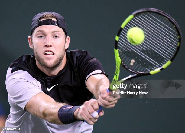 Jack Sock of the United States plays a backhand in his match against Feliciano Lopez of Spain during the BNP Paribas Open at the Indian Wells Tennis...