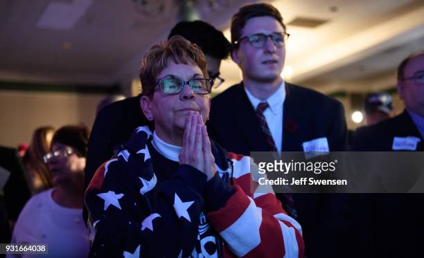 Bobbi Bauer prays for her candidate while watching election results at an Election Night event for GOP PA Congressional Candidate Rick Saccone as the...