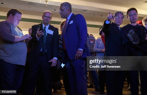 Supporters peruse early election results at an Election Night event for GOP PA Congressional Candidate Rick Saccone as the polls close on March 13,...