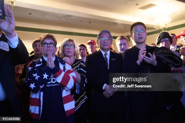 Supporters respond to early election results at an Election Night event for GOP PA Congressional Candidate Rick Saccone as the polls close on March...