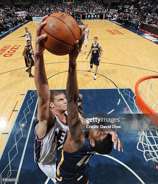 Solomon Jones of the Indiana Pacers blocks the shot of Brook Lopez of the New Jersey Nets during a game on November 17, 2009 at the IZOD Center in...