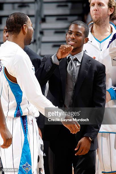 Chris Paul of the New Orleans Hornets gives teammate Marcus Thornton a pound at the beginning of a timeout during a game against the Los Angeles...