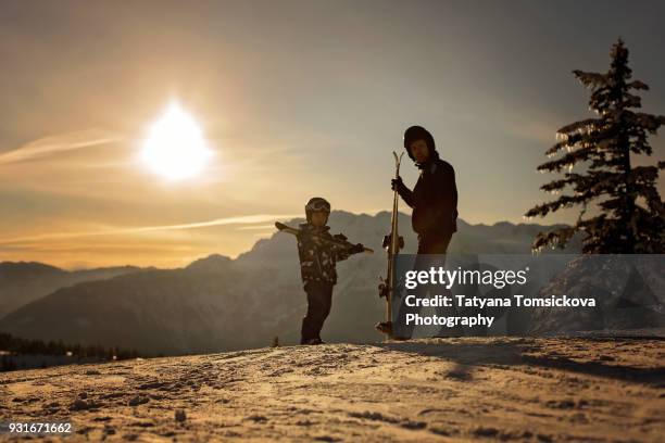 father and son, dad and child, skiing together in austrian resort, winter time - ski pants stock-fotos und bilder