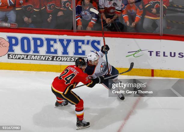 Travis Hamonic of the Calgary Flames battles against the Edmonton Oilers at Scotiabank Saddledome on March 13, 2018 in Calgary, Alberta, Canada.