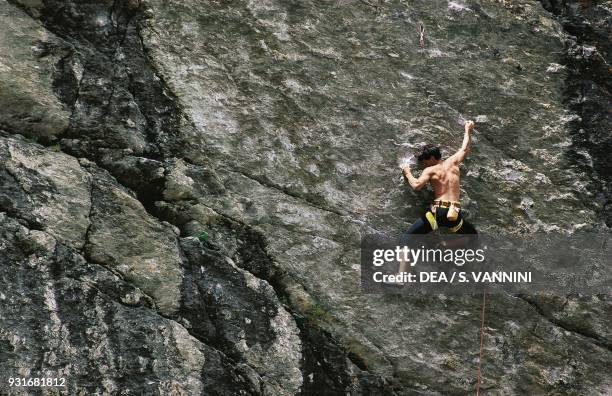 Mountaineer during a free climbing demonstration, climbing, Valgrisenche, Aosta Valley, Italy.