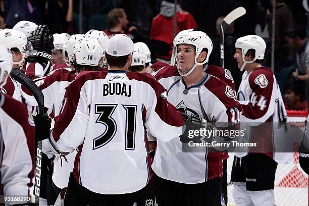 Scott Hannan and Peter Budaj of the Colorado Avalanche celebrate a win against the Calgary Flames on November 17, 2009 at Pengrowth Saddledome in...