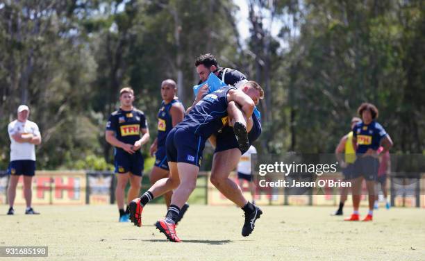 Bryce Cartwright tackles during a Gold Coast Titans NRL training session at Parkwood on March 14, 2018 in Gold Coast, Australia.