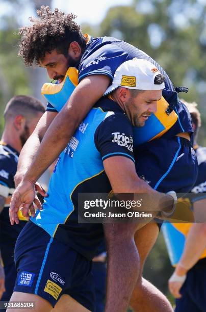 Michael Gordon and Tyrone Roberts-Davis perform tackling drills during a Gold Coast Titans NRL training session at Parkwood on March 14, 2018 in Gold...