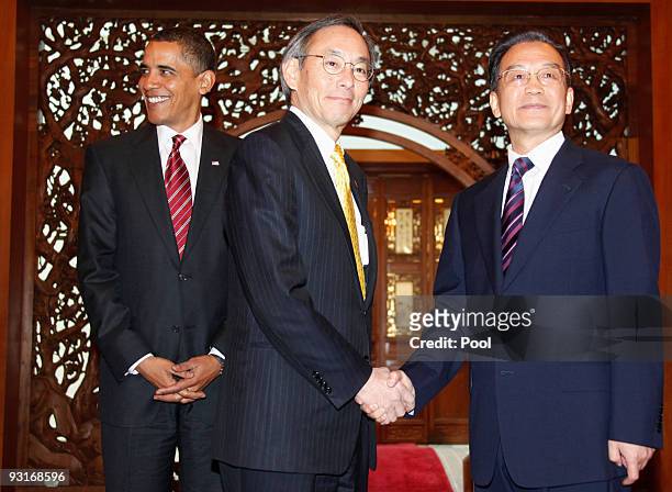 Energy Secretary Stephen Chu shakes hands with Chinese Premier Wen Jiabao, as U.S. President Barack Obama stands behind prior to their talks at the...