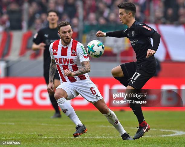Marco Hoeger of Koeln and Erik Thommy of Stuttgart battle for the ball during the Bundesliga match between 1. FC Koeln and VfB Stuttgart at...