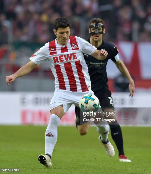 Milos Jojic of Koeln and Christian Gentner of Stuttgart battle for the ball during the Bundesliga match between 1. FC Koeln and VfB Stuttgart at...