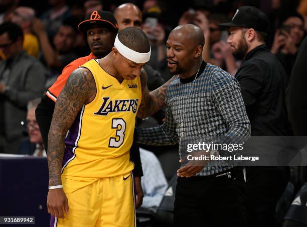 Isaiah Thomas of the Los Angeles Lakers talks to retired boxer Floyd Mayweather after the game against the Denver Nuggets on March 13, 2018 at...