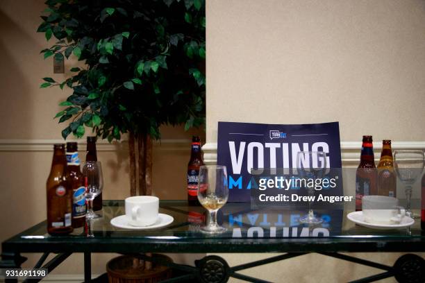 Discarded beer bottles and wine glasses sit on a table during an election night event for Conor Lamb, Democratic congressional candidate for...