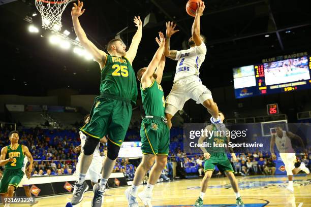 Middle Tennessee Blue Raiders guard Antwain Johnson shoots the ball over Vermont Catamounts forward Drew Urquhart and Vermont Catamounts guard David...