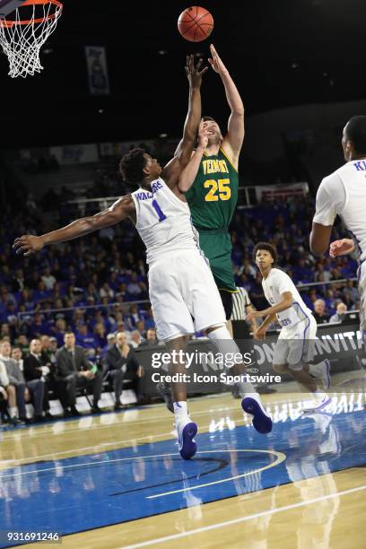 Vermont Catamounts forward Drew Urquhart shoots over Middle Tennessee Blue Raiders forward Brandon Walters during the third quarter of the NIT first...