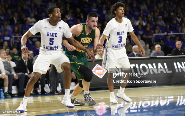 Middle Tennessee Blue Raiders forward Nick King and Vermont Catamounts forward Drew Urquhart fight for position during the third quarter of the NIT...
