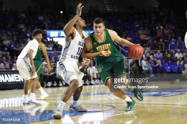 Vermont Catamounts forward Drew Urquhart drives to the basket during the third quarter of the NIT first round basketball game between the University...