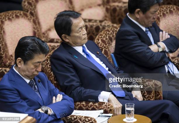Shinzo Abe, Japan's prime minister, from left, Taro Aso, Japan's deputy prime minister and finance minister, and Toshimitsu Motegi, Japan's economic...