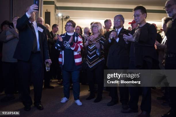 Attendees watch polling results during an election night rally with Rick Saccone, Republican candidate for the U.S. House of Representatives, not...