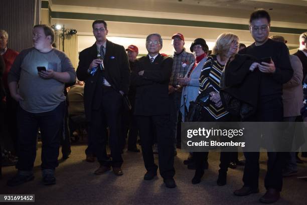 Attendees watch polling results during an election night rally with Rick Saccone, Republican candidate for the U.S. House of Representatives, not...