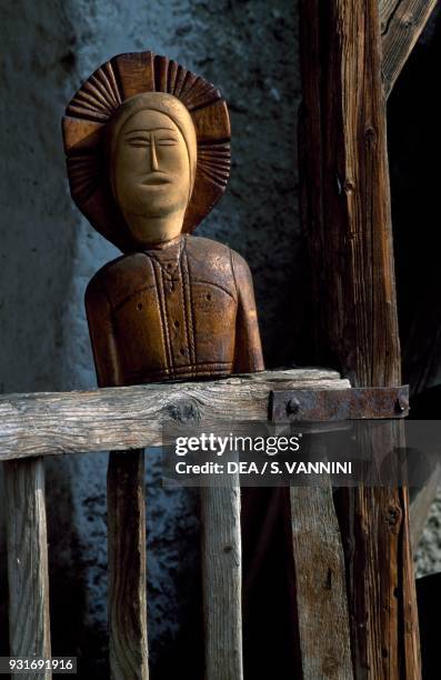Wooden statue at a typical dwelling, Allein-Daillon, Aosta Valley, Italy.