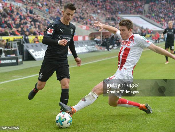 Erik Thommy of Stuttgart and Dominique Heintz of Koeln battle for the ball during the Bundesliga match between 1. FC Koeln and VfB Stuttgart at...