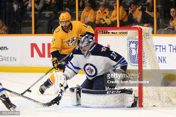 Winnipeg Jets goalie Connor Hellebuyck makes a save during the NHL game between the Nashville Predators and Winnipeg Jets, held on March 13 at...