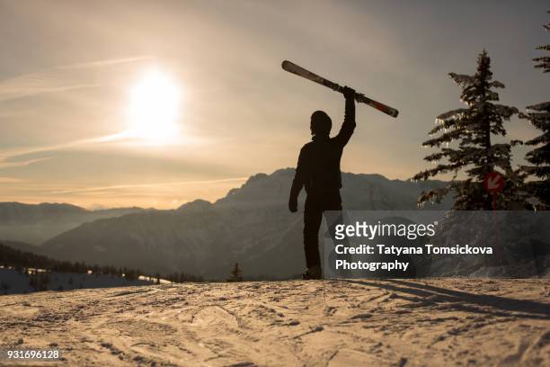 young man, skiing on sunset in austrian alps, winter scenery sunset landscape - baby sturzhelm stock-fotos und bilder
