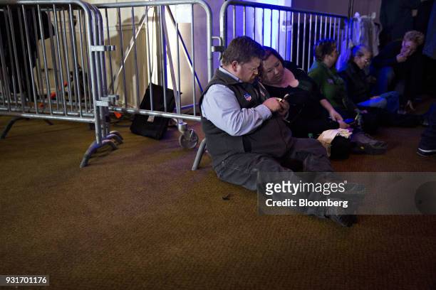 Attendees sit on the floor during an election night rally with Conor Lamb, Democratic candidate for the U.S. House of Representatives, not pictured,...