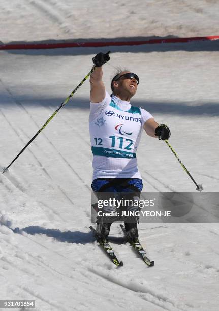 Andrew Soule of the US celebrates his victory after crossing the finish line in the men's 1.1km sprint sitting cross-country skiing final event of...